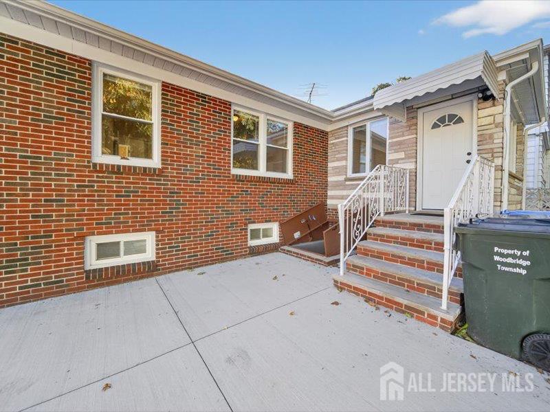 54 Freeman Street Woodbridge, NJ 07095 - Photo 4 of 35 a view of house with stairs and wooden fence
