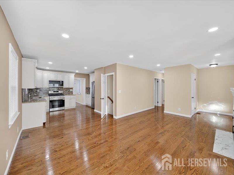 54 Freeman Street Woodbridge, NJ 07095 - Photo 9 of 35 a view of kitchen dining table chairs microwave and cabinets