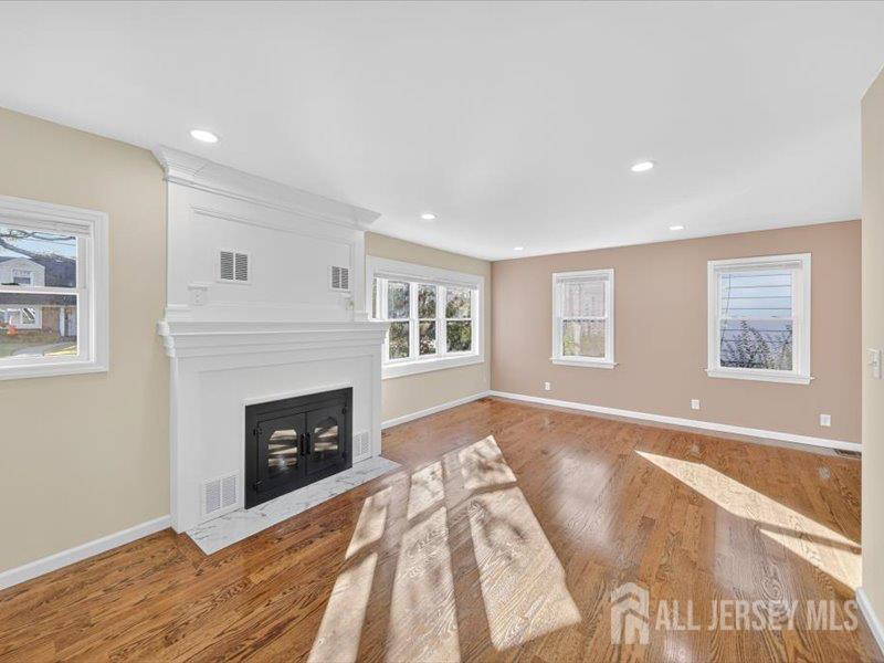 54 Freeman Street Woodbridge, NJ 07095 - Photo 10 of 35 a living room with furniture and a fireplace