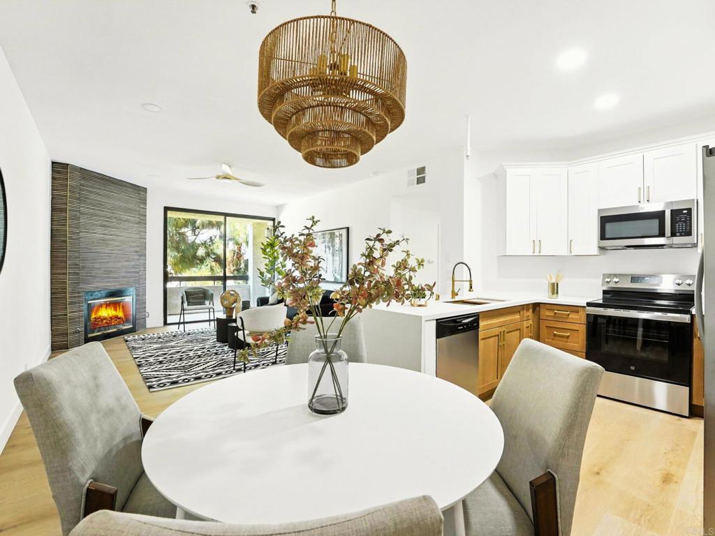 5875 Friars Road, Unit 4307 San Diego, CA 92110 - Photo 4 of 30 a dining room with furniture a kitchen and chandelier
