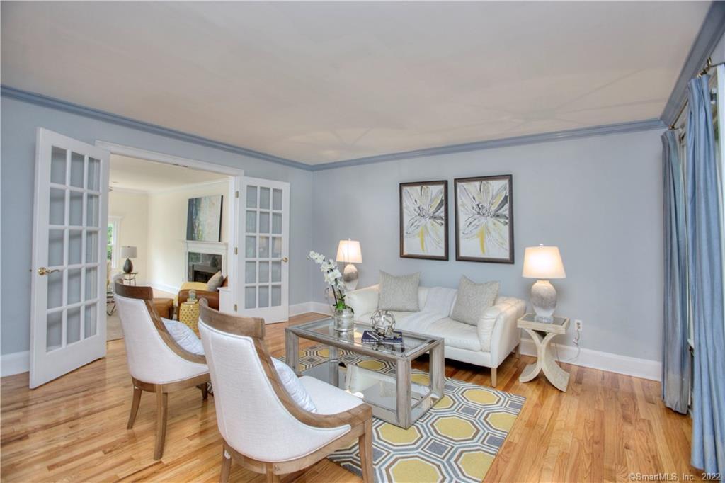 99 South Benson Road Fairfield, CT 06824 - Photo 1 of 1 To the right, the formal living room features large windows and French doors to the sunken Family Room. Contrasting gloss blue crown moulding gives this space a designer touch. Other possible uses are an office, playroom, or even sleeping quarters for guests with some minor modifications.