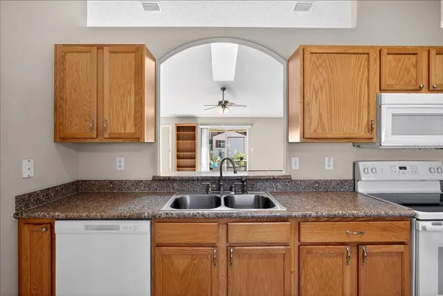 a kitchen with sink and cabinets