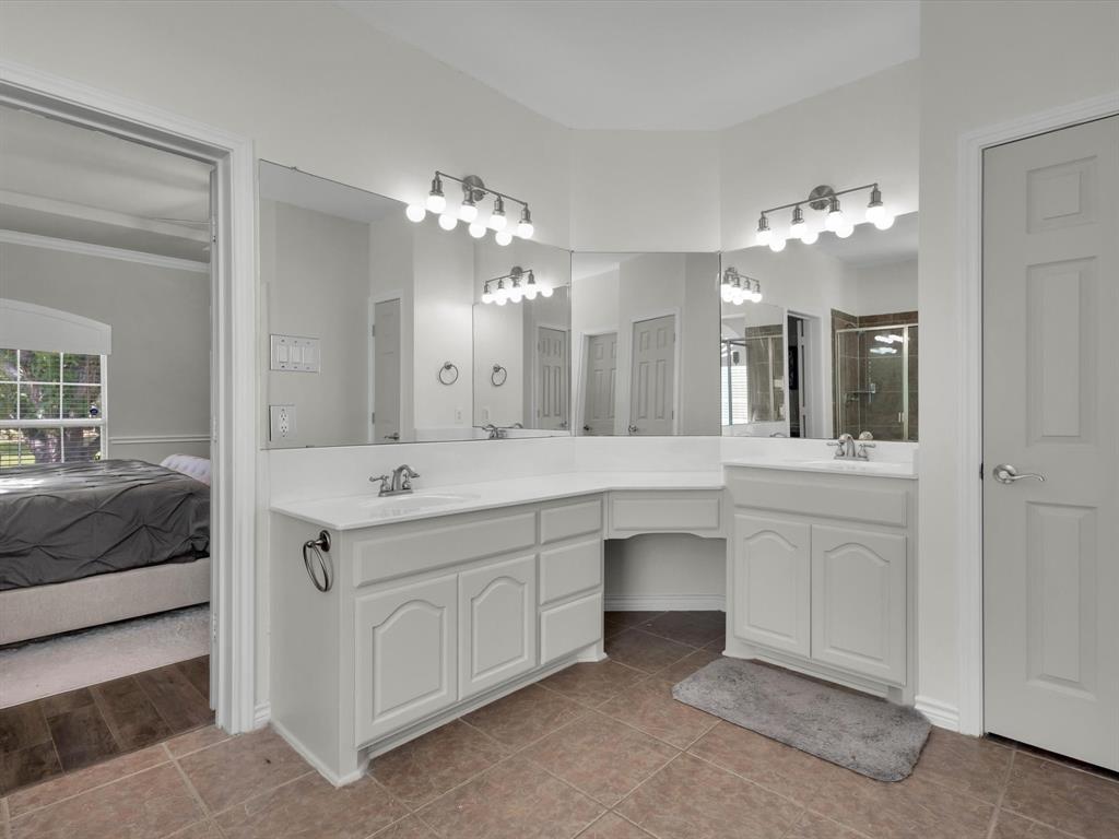 1803 Timber Ridge Drive Frisco, TX 75036 - Photo 22 of 40 Full bath with double vanity, light tile patterned floors, a stall shower, and ensuite bathroom