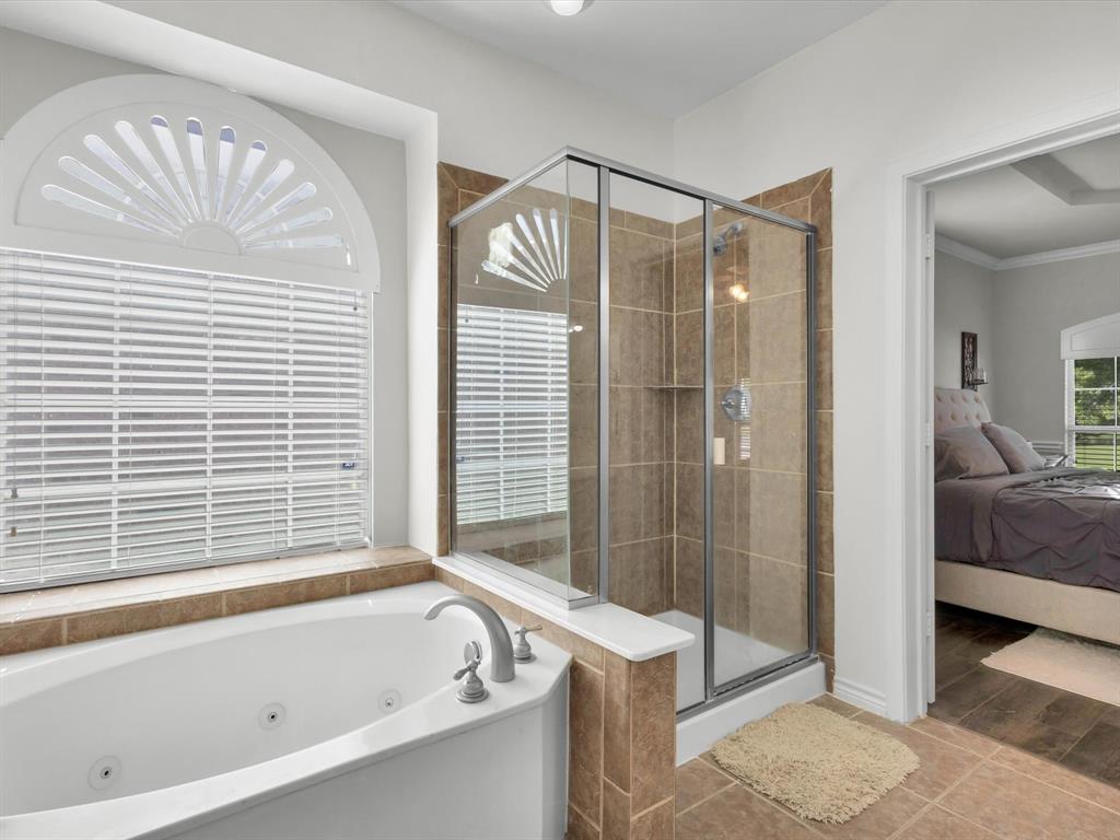 1803 Timber Ridge Drive Frisco, TX 75036 - Photo 23 of 40 Full bathroom with a tub with jets, ensuite bathroom, a shower stall, tile patterned flooring, and ornamental molding