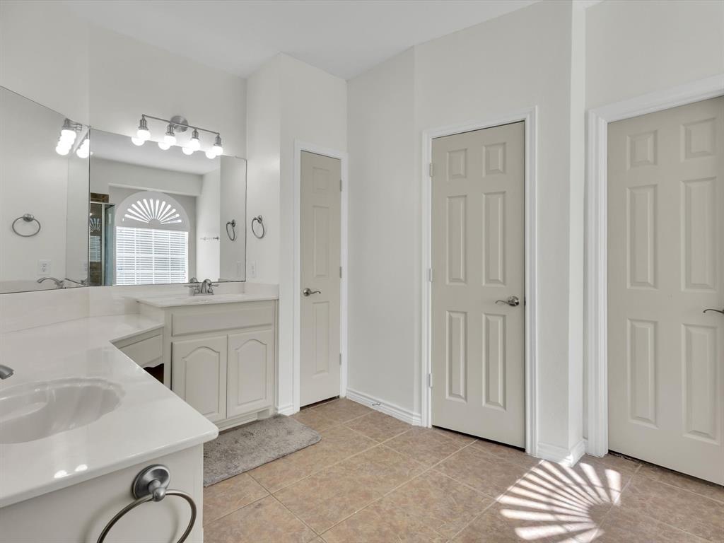 1803 Timber Ridge Drive Frisco, TX 75036 - Photo 24 of 40 Bathroom featuring two vanities, double vanity, light tile patterned floors, and a shower