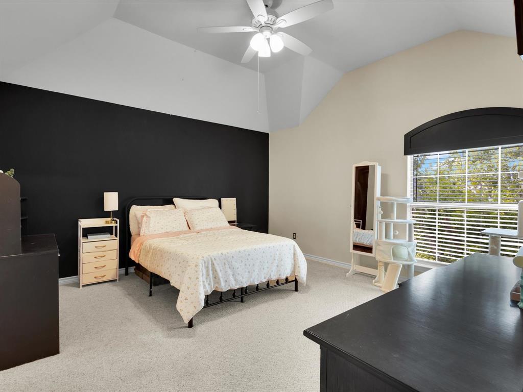1803 Timber Ridge Drive Frisco, TX 75036 - Photo 29 of 40 Bedroom with vaulted ceiling, light carpet, and ceiling fan