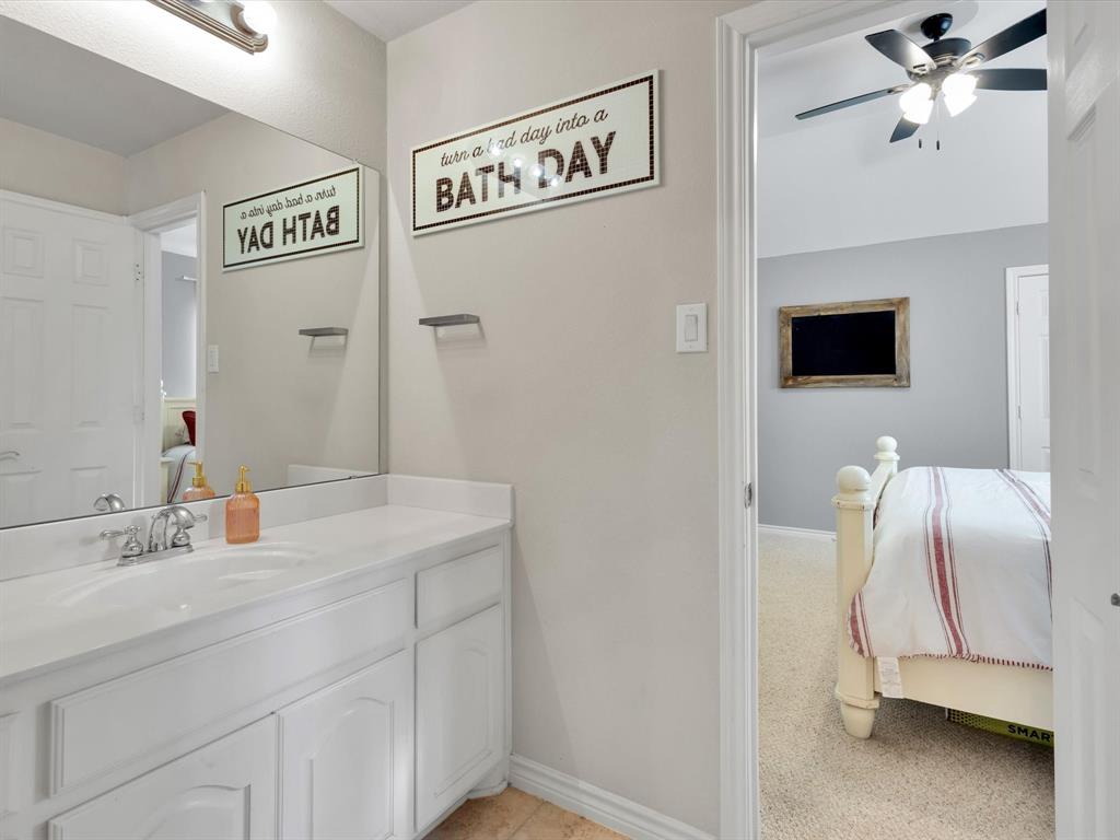 1803 Timber Ridge Drive Frisco, TX 75036 - Photo 30 of 40 Bathroom featuring ensuite bath, vanity, light carpet, and ceiling fan