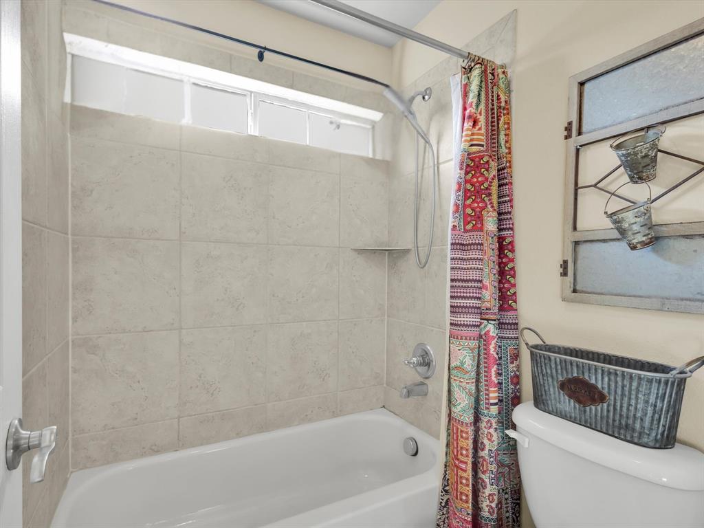 1803 Timber Ridge Drive Frisco, TX 75036 - Photo 31 of 40 Bathroom featuring shower / bath combo and toilet