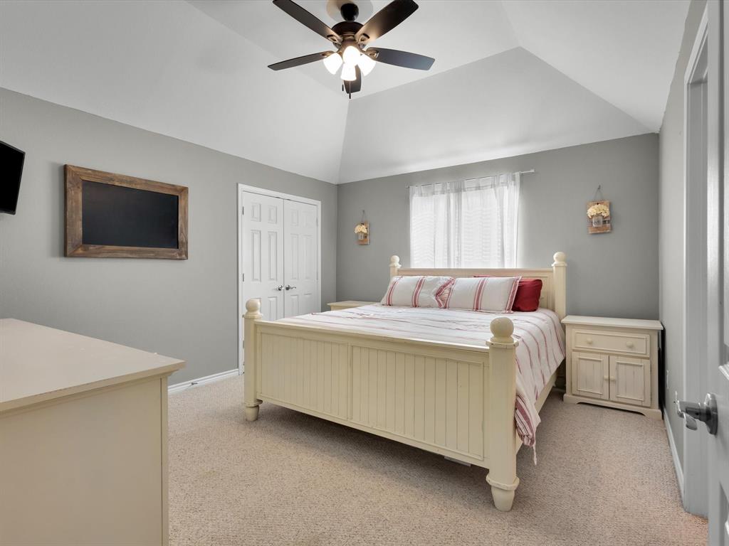 1803 Timber Ridge Drive Frisco, TX 75036 - Photo 32 of 40 Bedroom featuring light colored carpet, a ceiling fan, a closet, and lofted ceiling