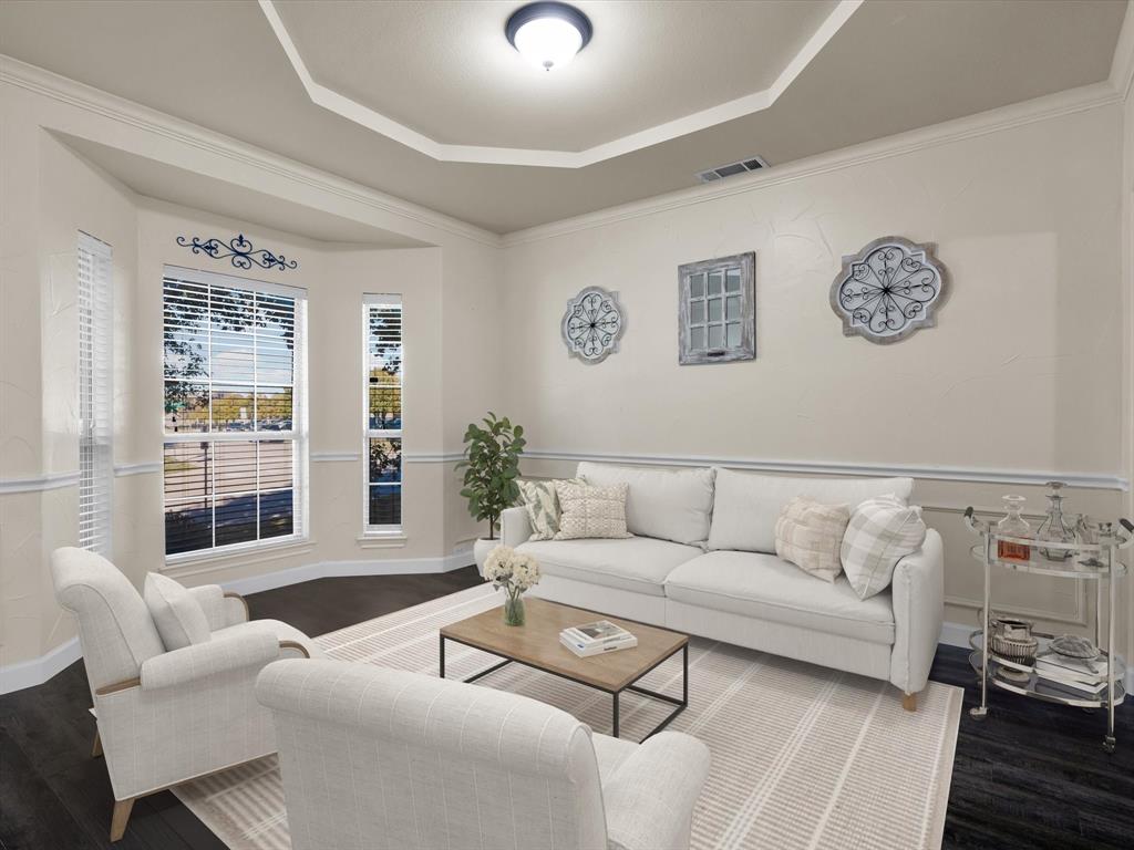 1803 Timber Ridge Drive Frisco, TX 75036 - Photo 8 of 40 Virtually staged Living area with dark wood finished floors, crown molding, and a tray ceiling