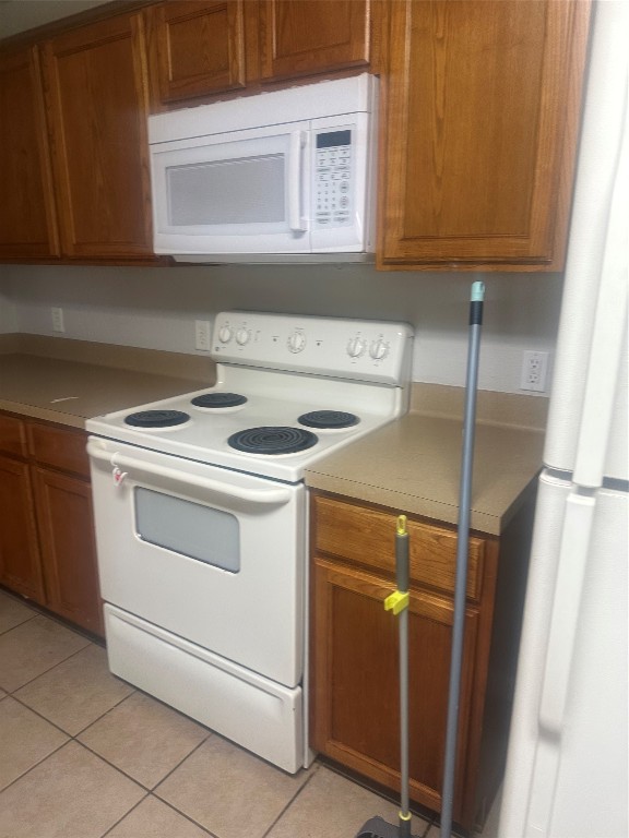 23269 High Point Street, Unit 71 Prairie View, TX 77445 - Photo 29 of 31 a kitchen with white cabinets and white appliances