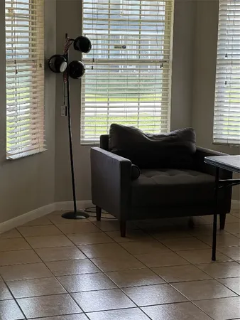 a view of a room with furniture and wooden floor