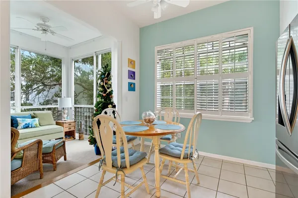 a dining room with furniture and large windows