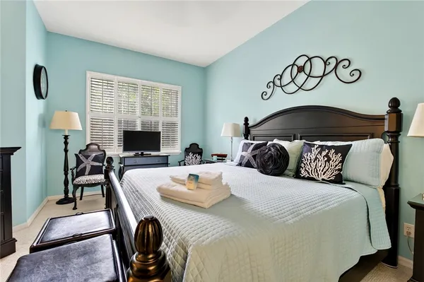 a bed room with a bed and a chair