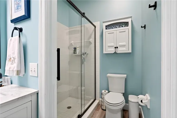 a bathroom with a granite countertop toilet sink and shower