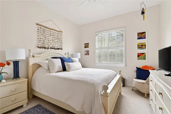 a bedroom with a bed and a tv