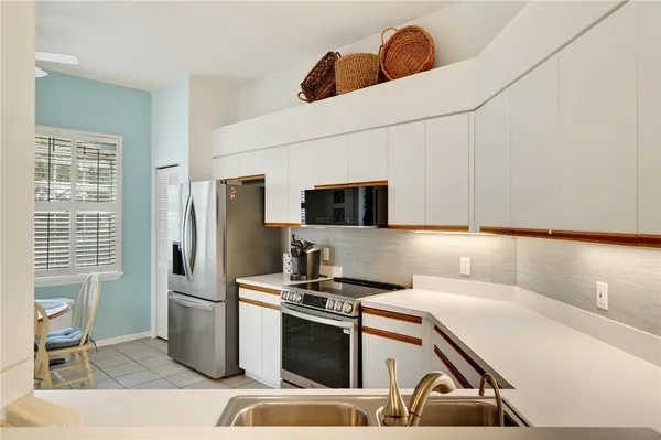 a kitchen with stainless steel appliances a refrigerator and a stove top oven