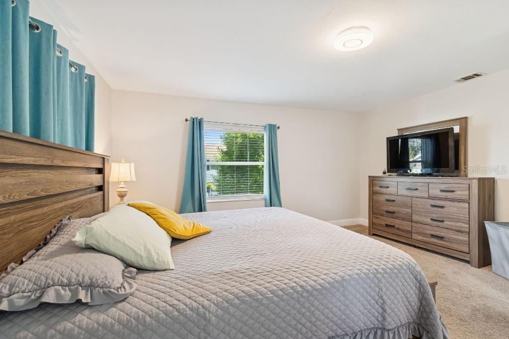 13125 Wilcox Road, Unit 6205 Largo, FL 33774 - Photo 27 of 48 a bedroom with a bed and flat screen tv