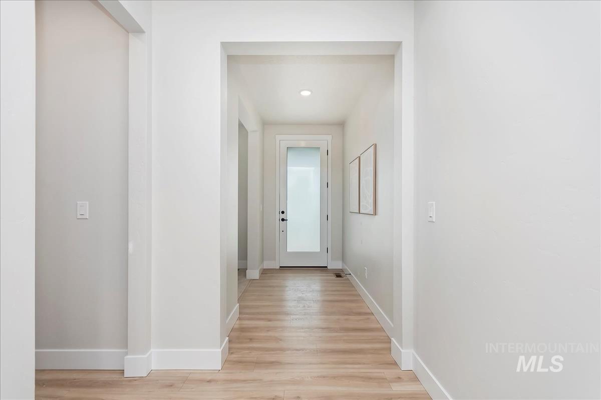 2702 West Gidran Meridian, ID 83642 - Photo 14 of 30 Hallway with baseboards and light wood-style floors