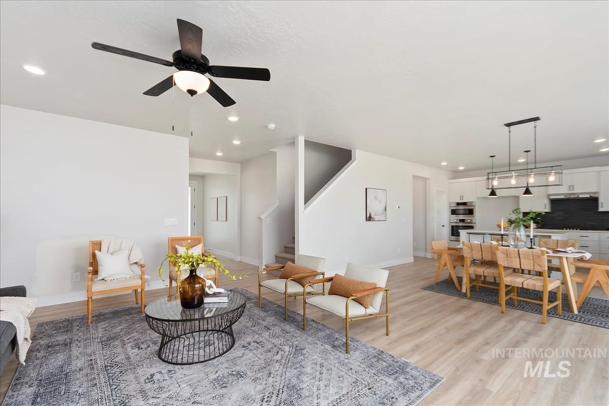 2702 West Gidran Meridian, ID 83642 - Photo 5 of 30 Living area with stairs, light wood-style floors, recessed lighting, and a ceiling fan