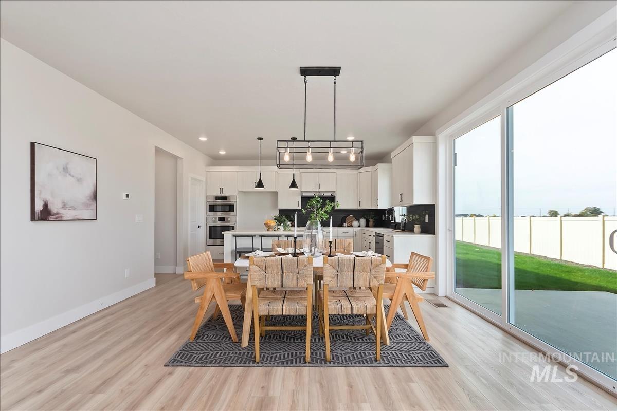 2702 West Gidran Meridian, ID 83642 - Photo 8 of 30 Dining area featuring light wood finished floors and recessed lighting