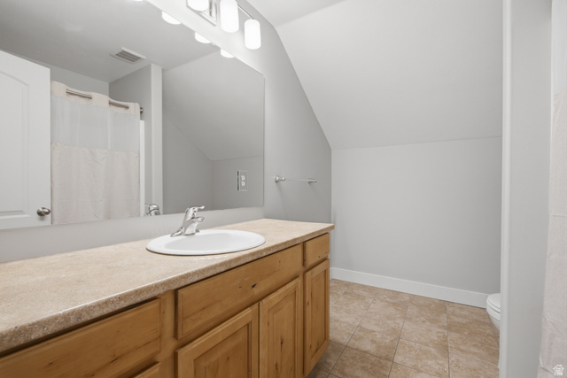 1252 Skyline Road Saratoga Springs, UT 84045 - Photo 32 of 51 Light wood-finish vanity cabinetry with an integrated countertop, undermount sink, and polished chrome faucet