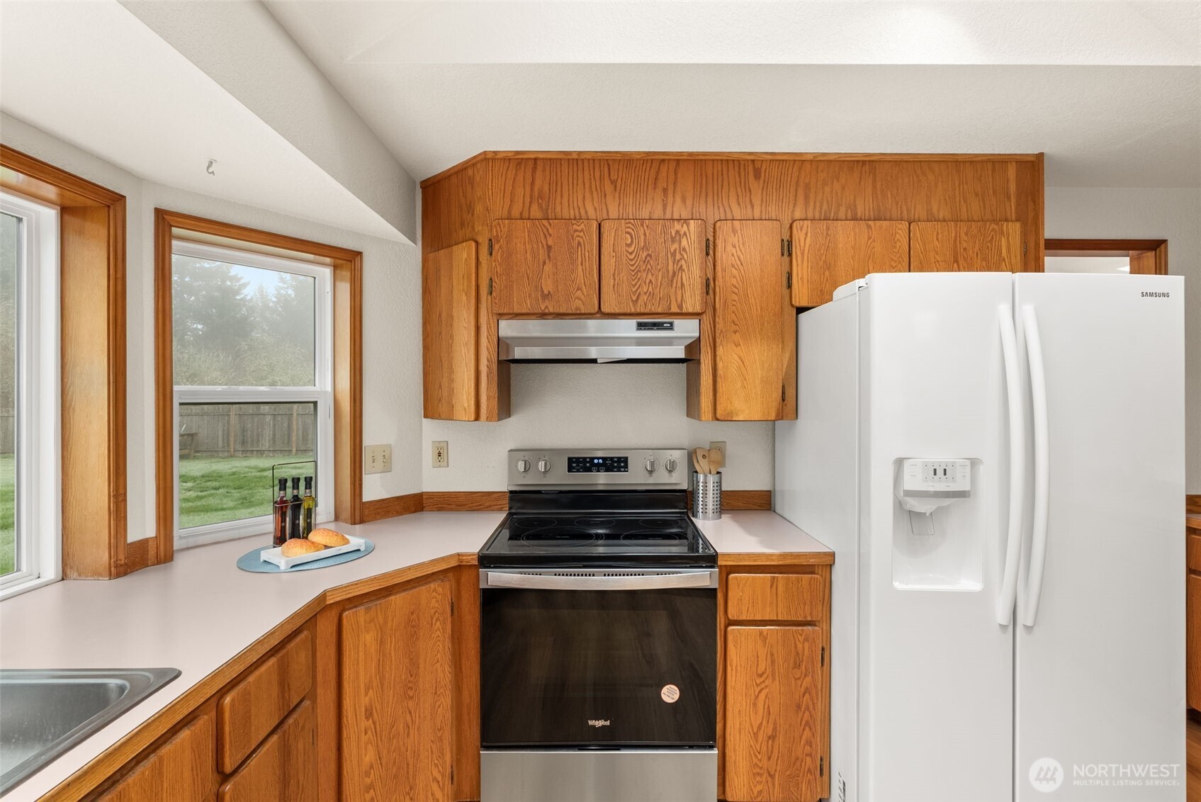 3724 Golden Eagle Loop Southeast Olympia, WA 98513 - Photo 21 of 40 a kitchen with stainless steel appliances a stove a refrigerator and a sink