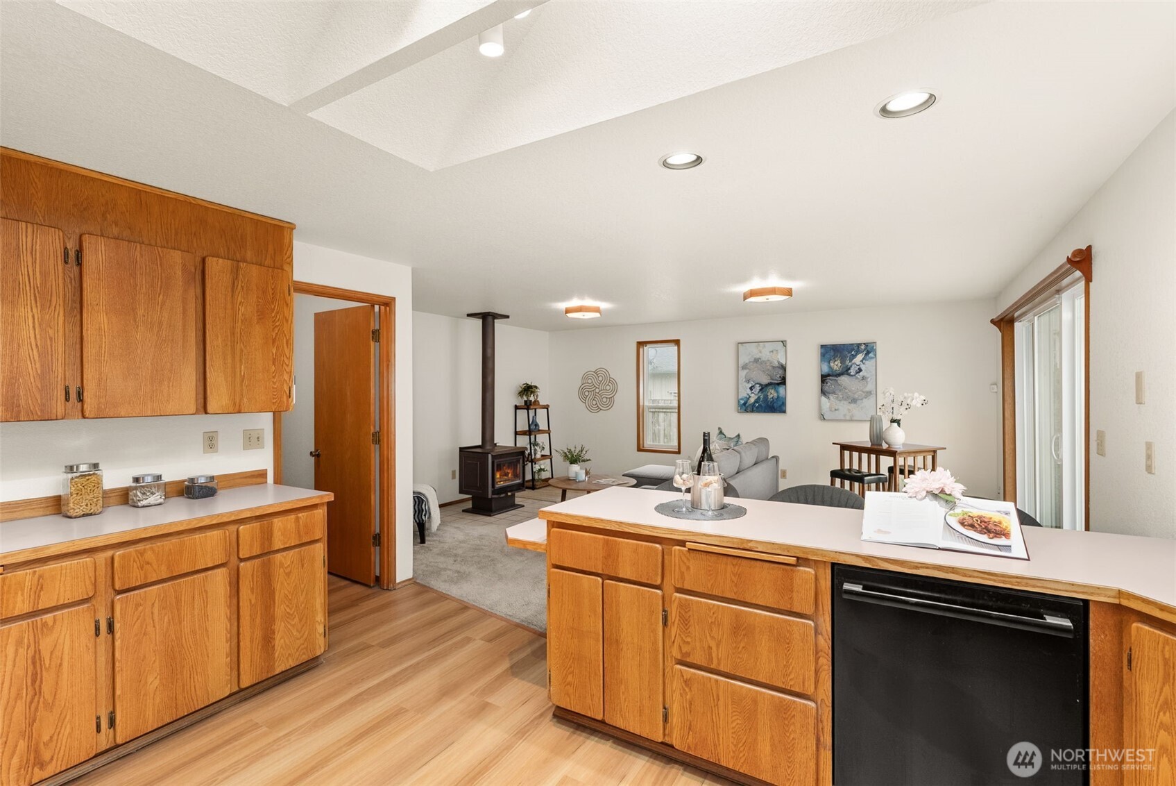 3724 Golden Eagle Loop Southeast Olympia, WA 98513 - Photo 22 of 40 a room with stainless steel appliances kitchen island granite countertop a sink dishwasher stove and cabinets with wooden floor