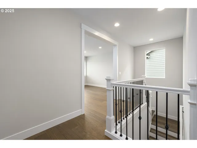 a view of hallway with wooden floor