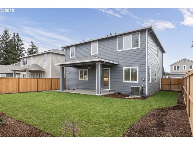 a view of a yard in front of a house with plants and a big yard