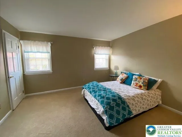 a spacious bedroom with a bed and window