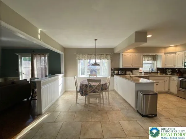 a large kitchen with a table and chairs