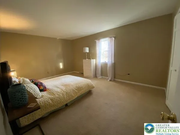 a bedroom with a bed and a night stand