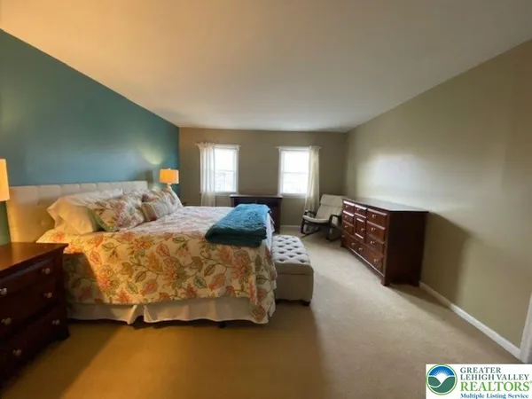 a spacious bedroom with a bed and window