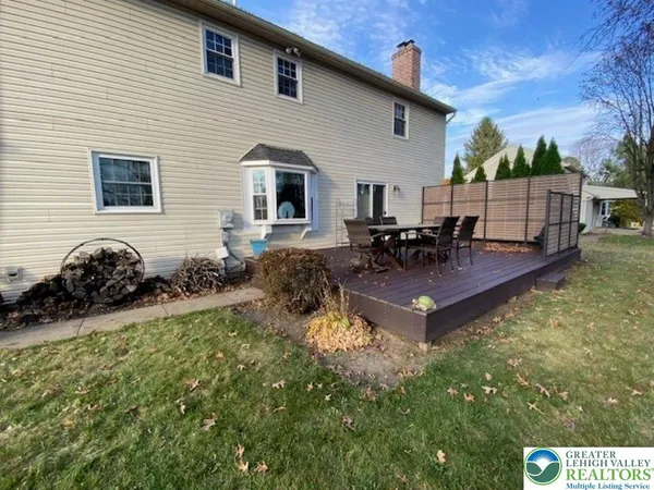 a view of a patio with table and chairs and potted plants