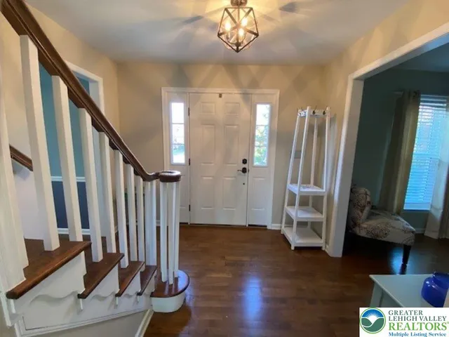 a view of an entryway with wooden floor and staircase