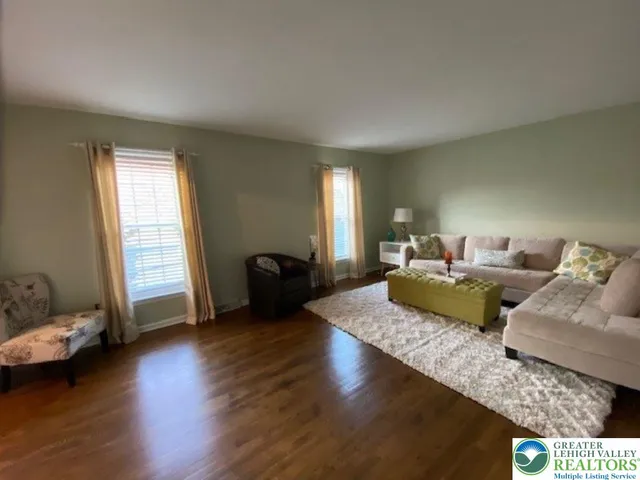 a living room with furniture window and wooden floor