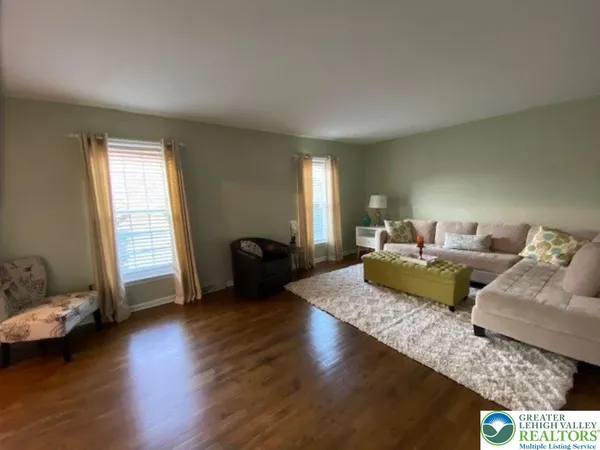 a living room with furniture window and wooden floor