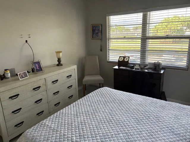 a bedroom with a bed and two windows