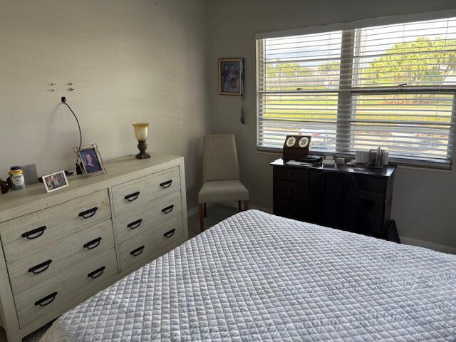 313 Dorset H, Unit 313 Boca Raton, FL 33434 - Photo 14 of 20 a bedroom with a bed and two windows