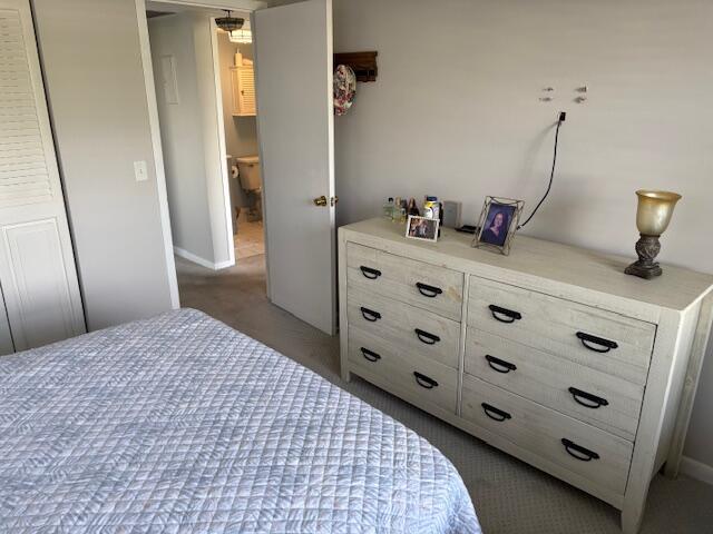 313 Dorset H, Unit 313 Boca Raton, FL 33434 - Photo 16 of 20 a bedroom with a bed and a dresser
