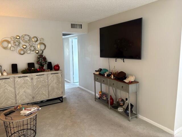 313 Dorset H, Unit 313 Boca Raton, FL 33434 - Photo 10 of 20 a living room with furniture and a flat screen tv