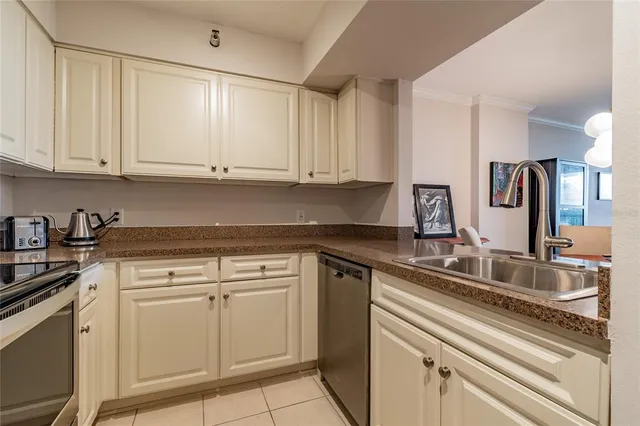 a kitchen with a sink cabinets and stainless steel appliances