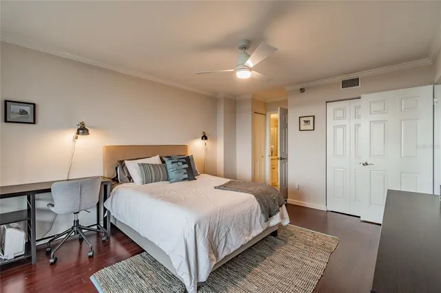 a bedroom with a large bed and a window