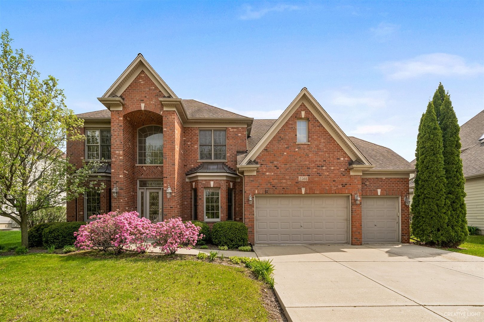 2508 Champion Road Naperville, IL 60564 - Photo 1 of 1 a front view of a house with a yard and garage