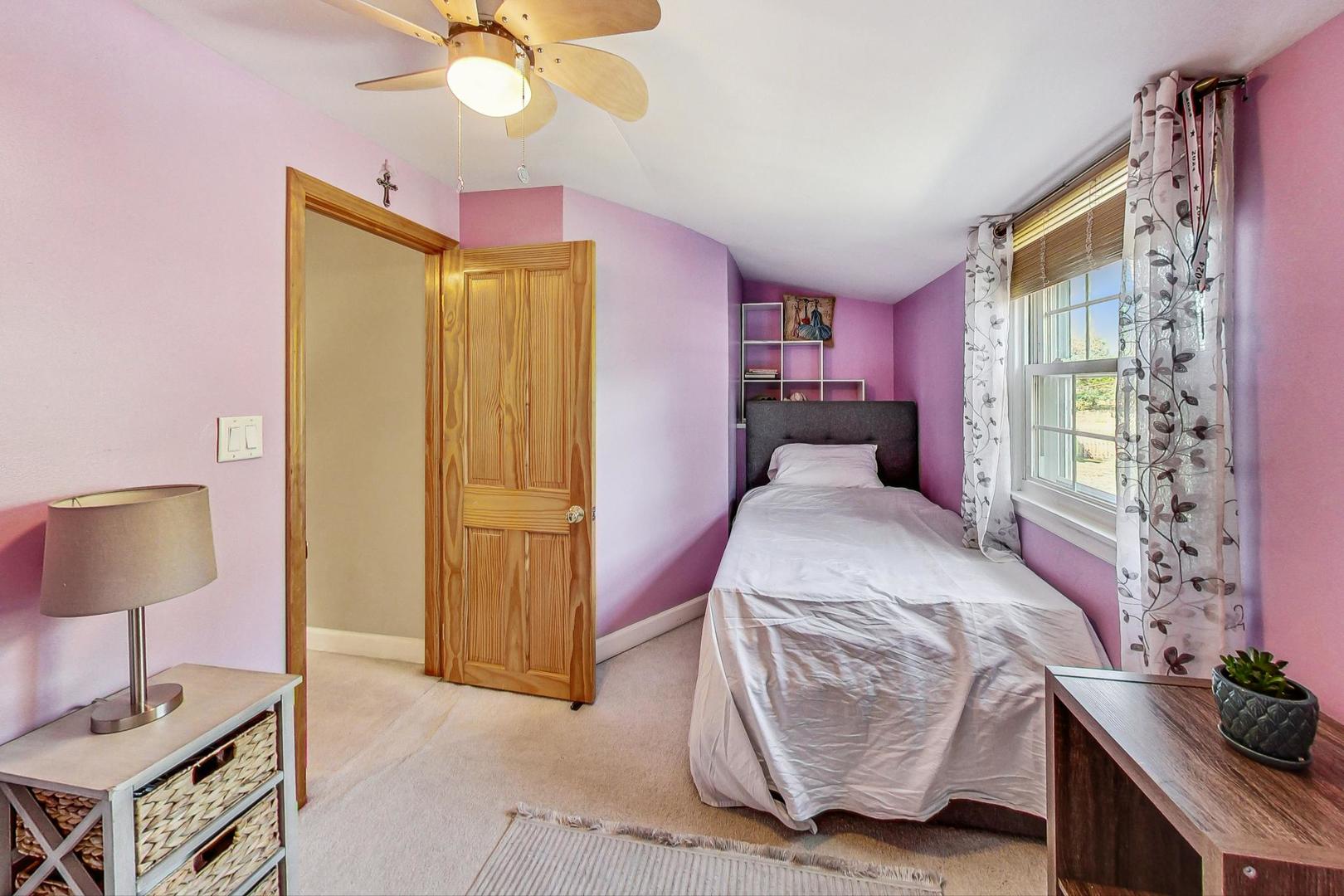 1738 Morse Avenue Des Plaines, IL 60018 - Photo 15 of 31 a bedroom with a bed and a chandelier
