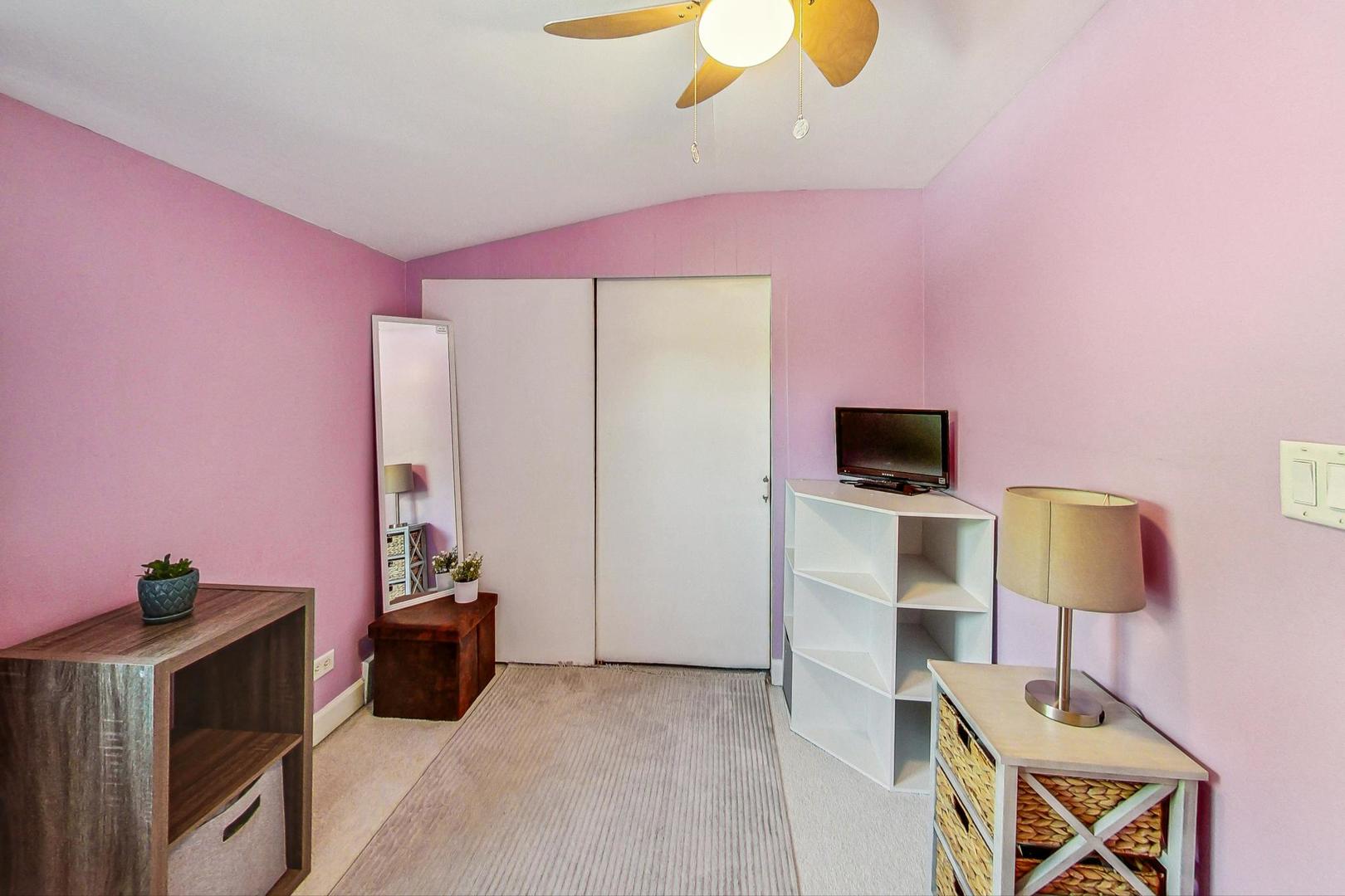 1738 Morse Avenue Des Plaines, IL 60018 - Photo 16 of 31 a bedroom with furniture and a flat screen tv