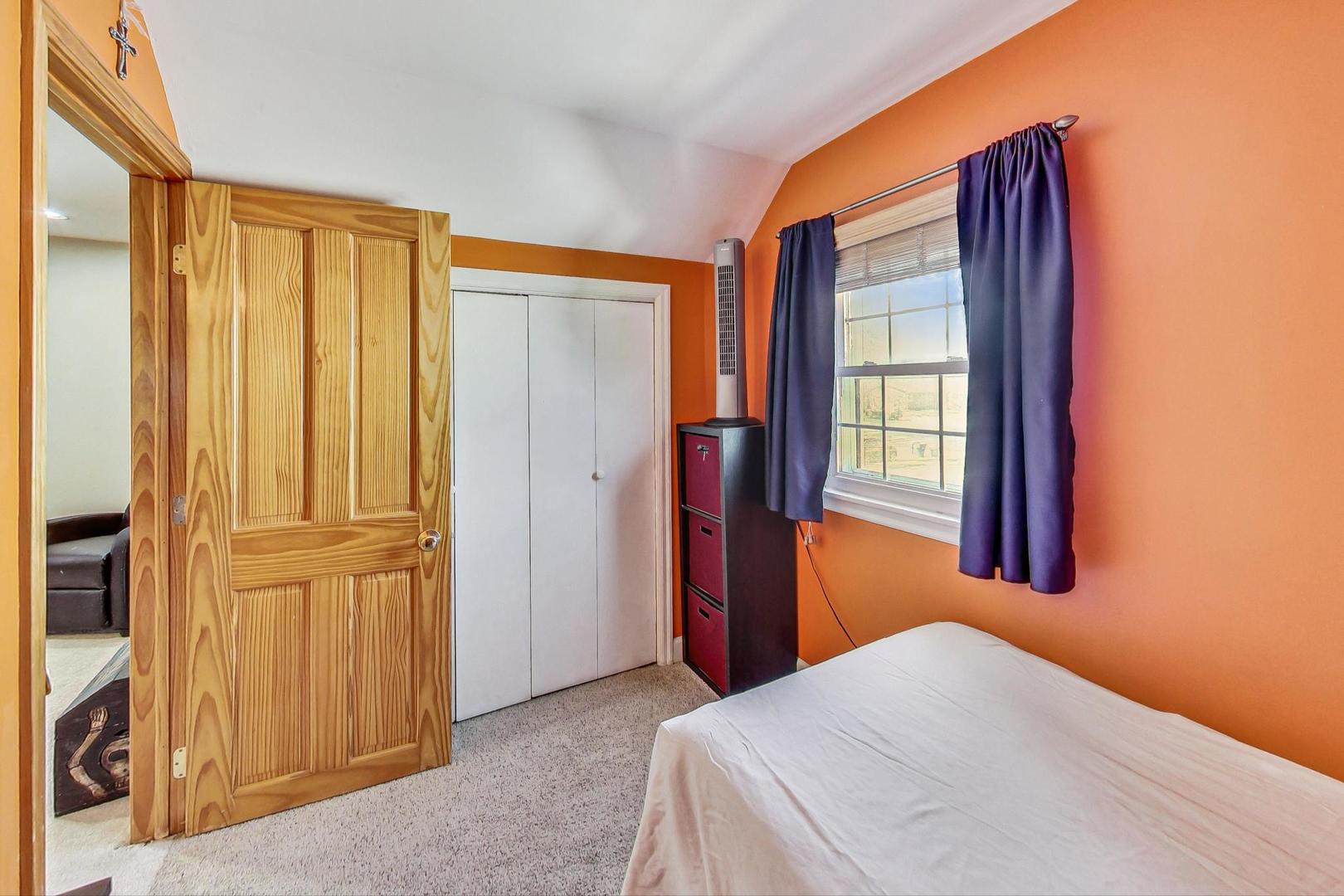 1738 Morse Avenue Des Plaines, IL 60018 - Photo 17 of 31 a bedroom with a bed and a window