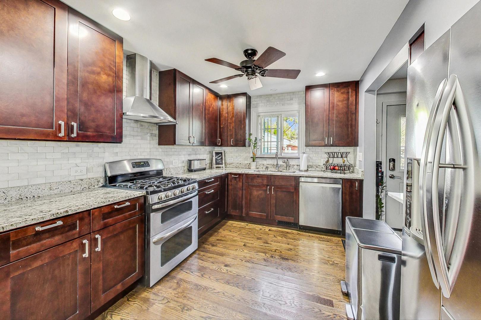 1738 Morse Avenue Des Plaines, IL 60018 - Photo 4 of 31 a kitchen with a sink stainless steel appliances and counter space