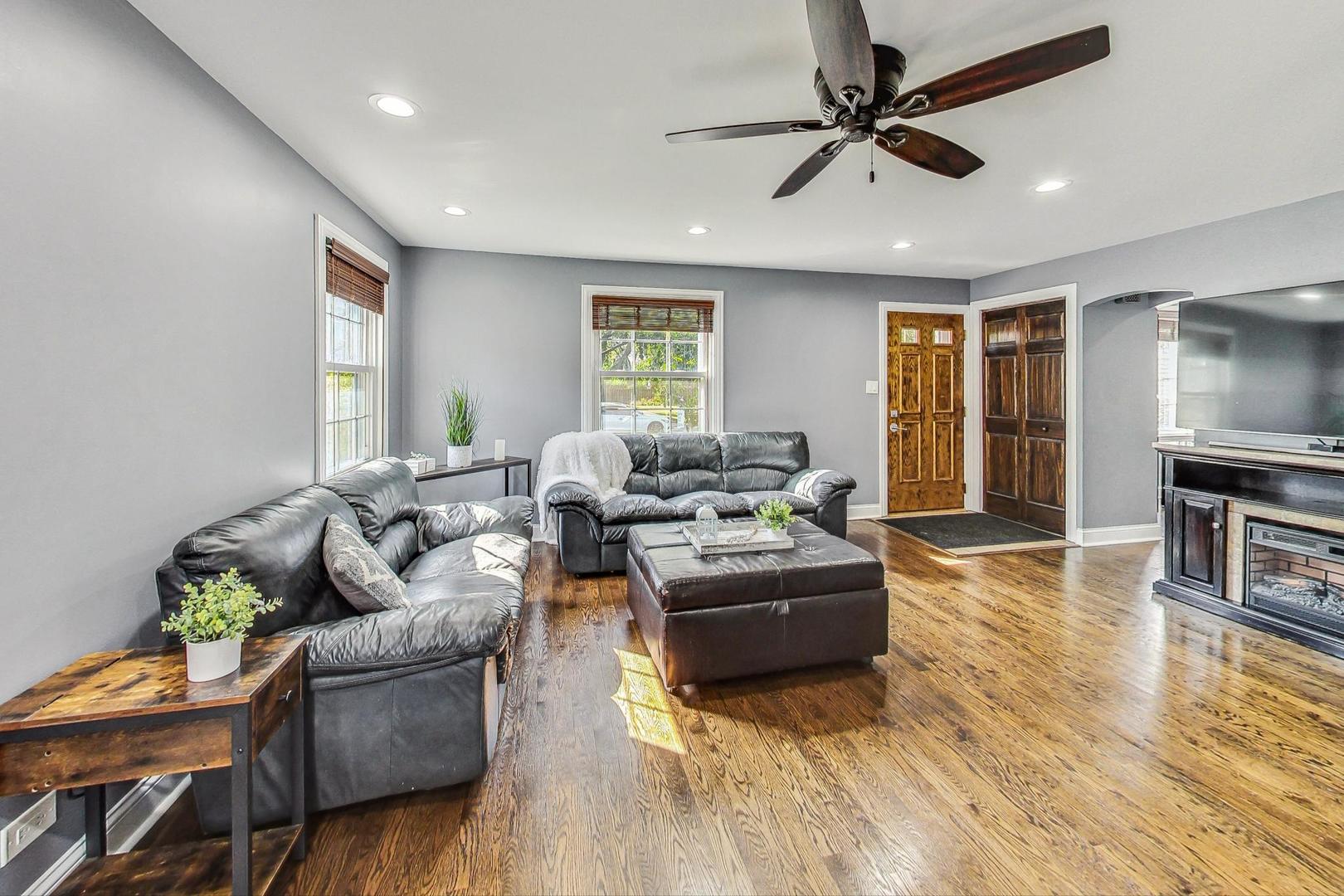 1738 Morse Avenue Des Plaines, IL 60018 - Photo 7 of 31 a living room with fireplace furniture and a wooden floor